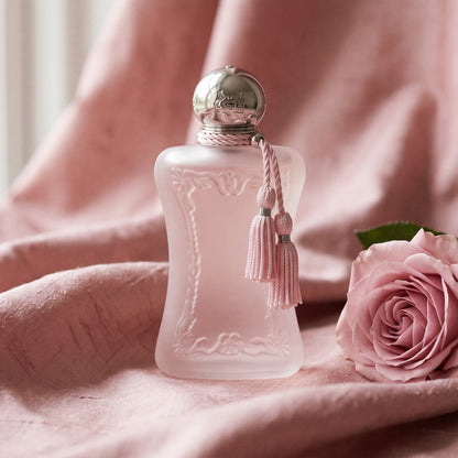 Parfums de Marly Delina la Rosee on champagne silk with a branch of wild rose in mid-bloom