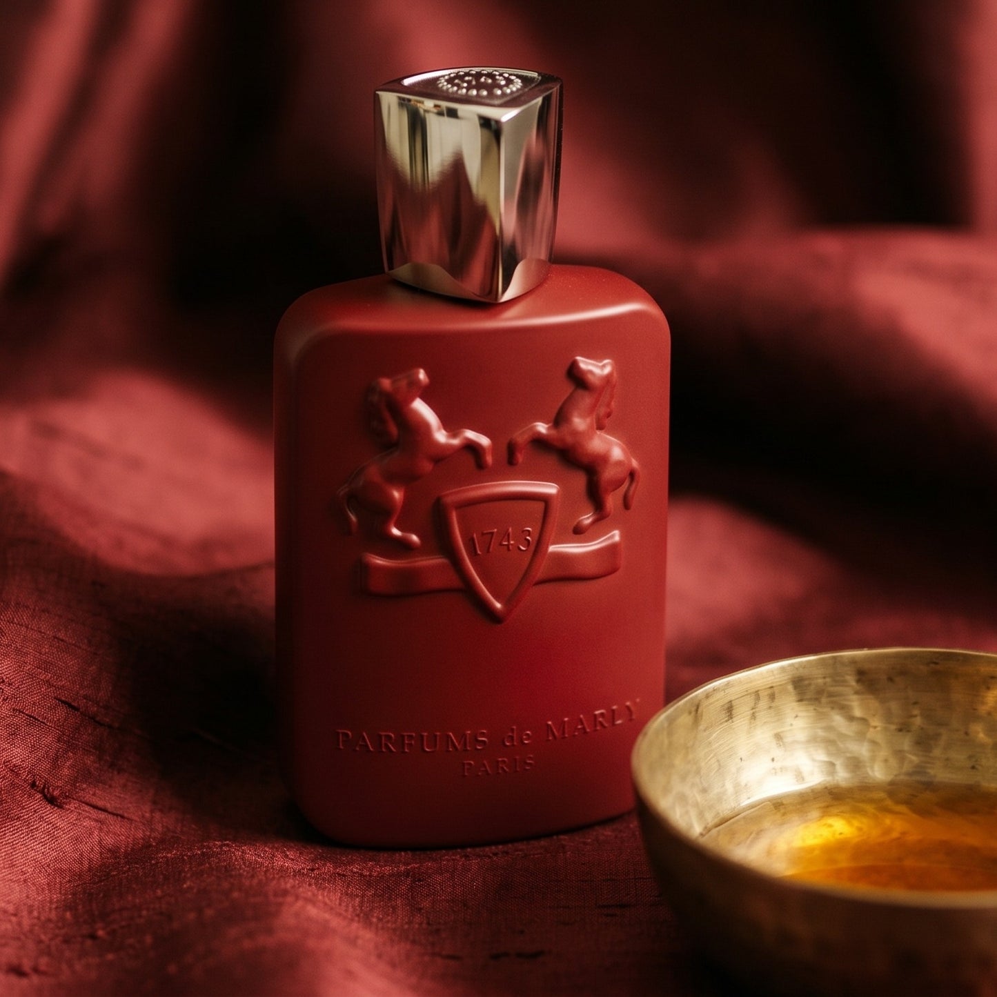 Parfums de Marly Kalan EDP on deep caramel velvet with a small copper jar of resin balm