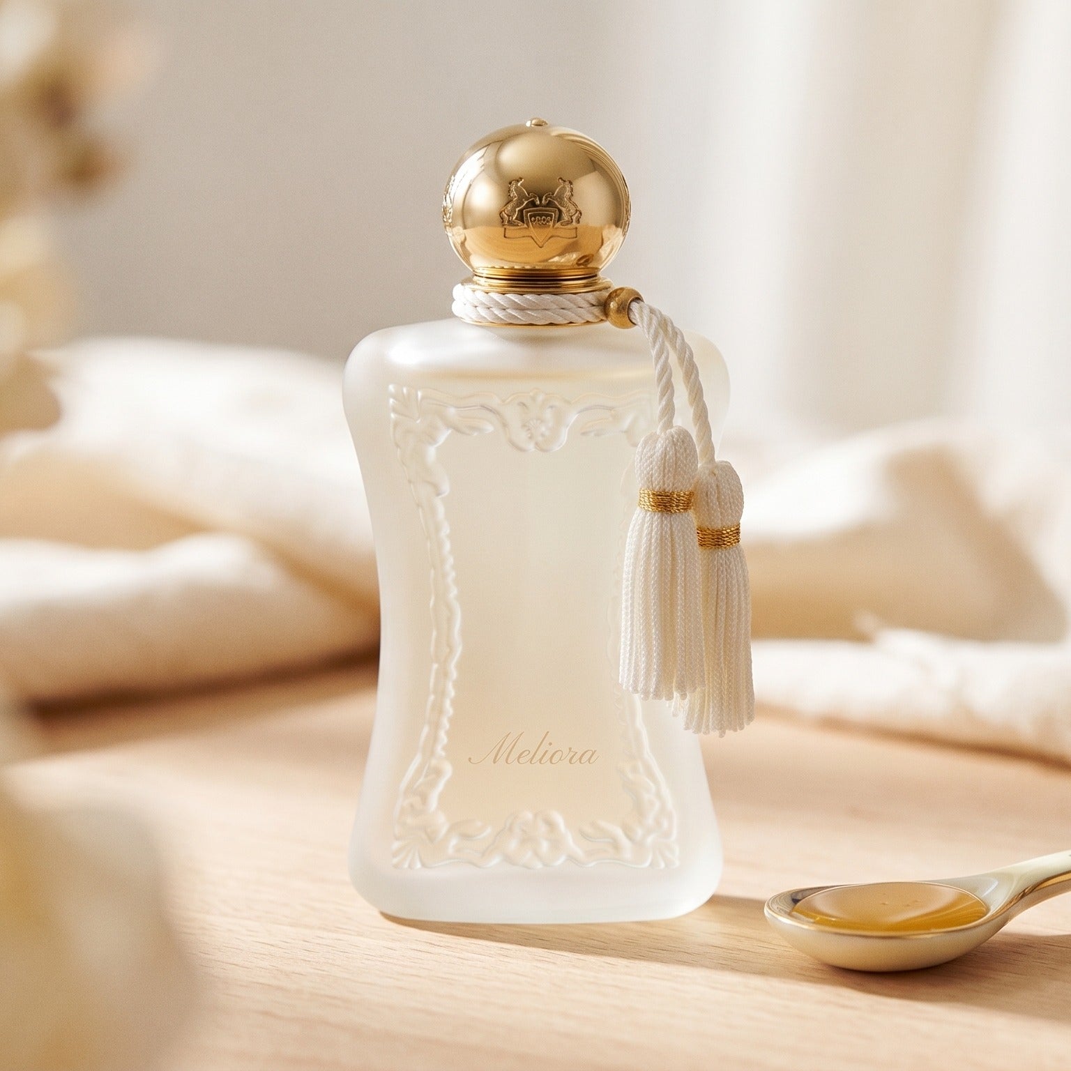 Parfums de Marly Meliora EDP on bleached oak with a shallow ramekin of salted caramel