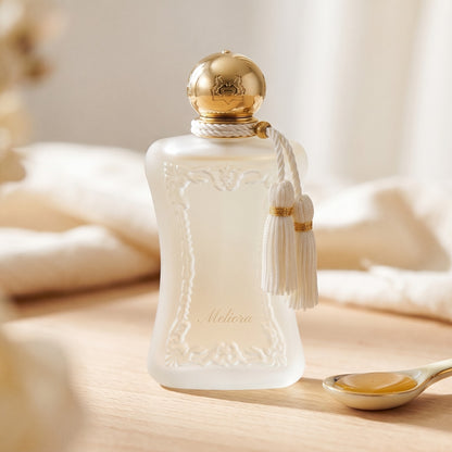 Parfums de Marly Meliora EDP on bleached oak with a shallow ramekin of salted caramel
