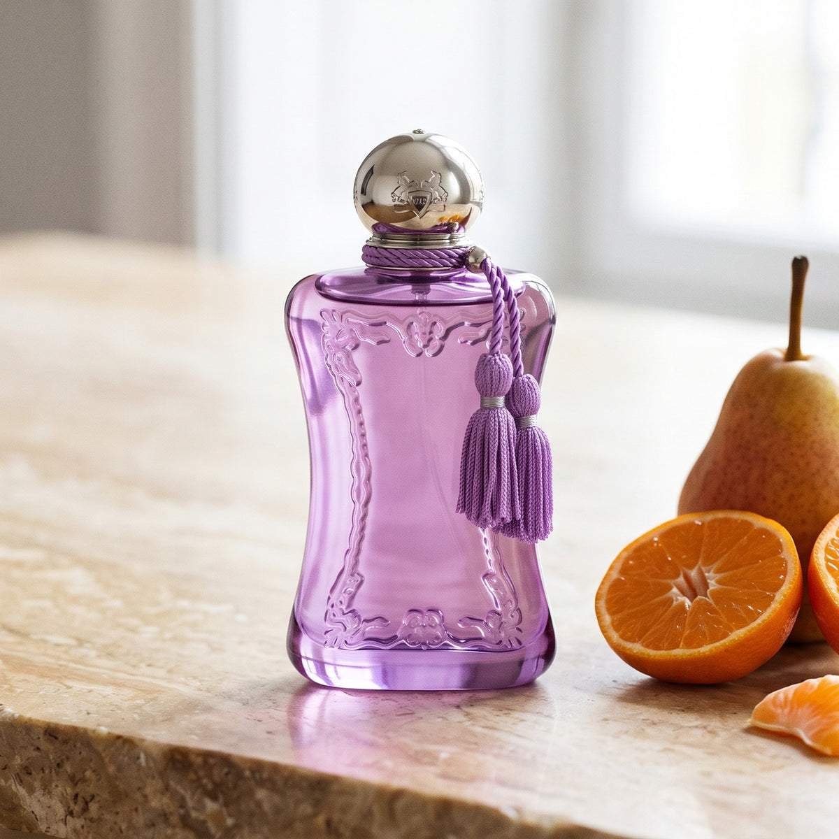 Parfums de Marly Palatine on polished limestone with a ripe pear beside halved mandarins