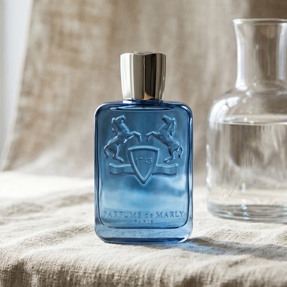 Parfums de Marly Sedley EDP on bleached canvas with a decanter of infused orange water