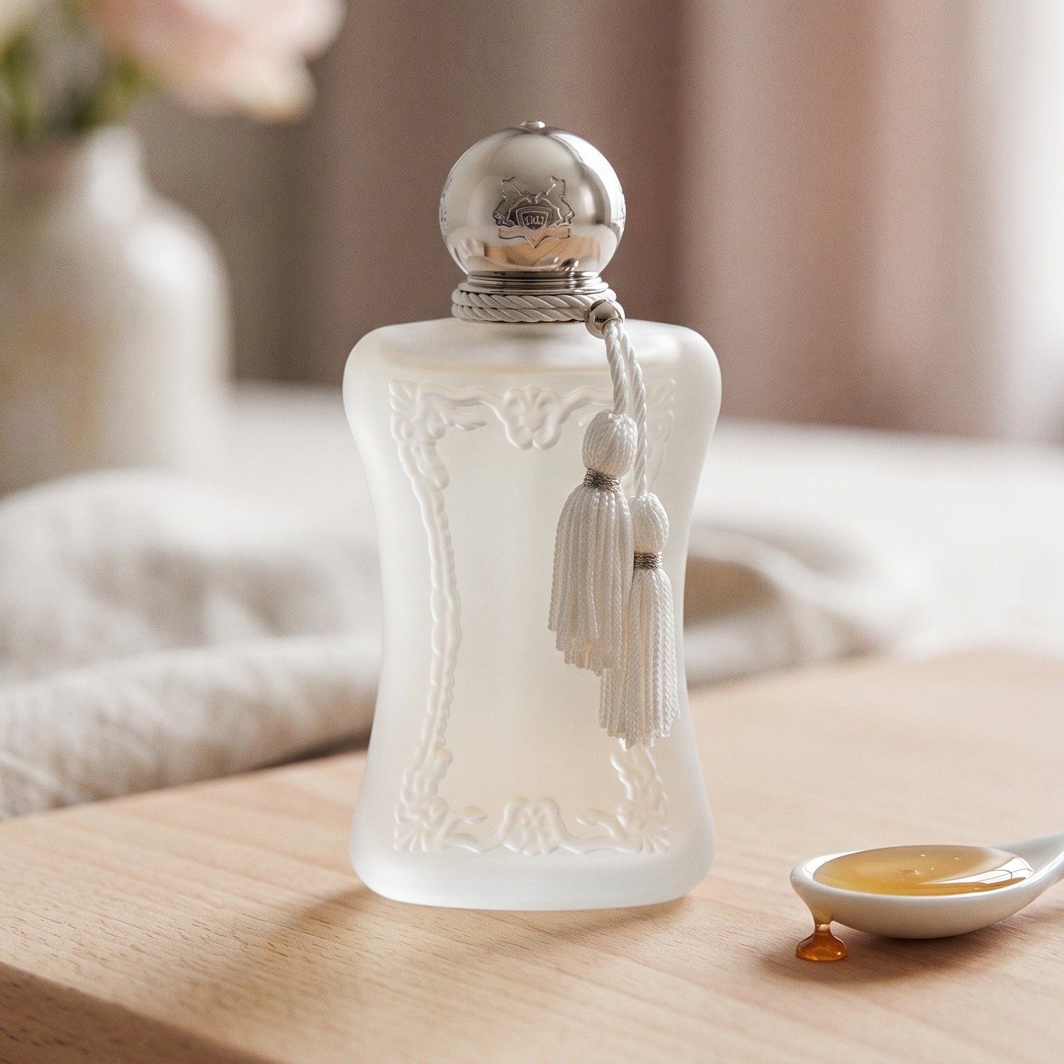 Parfums de Marly Valaya EDP on ivory-stained wood with a small bowl of crystallized ginger