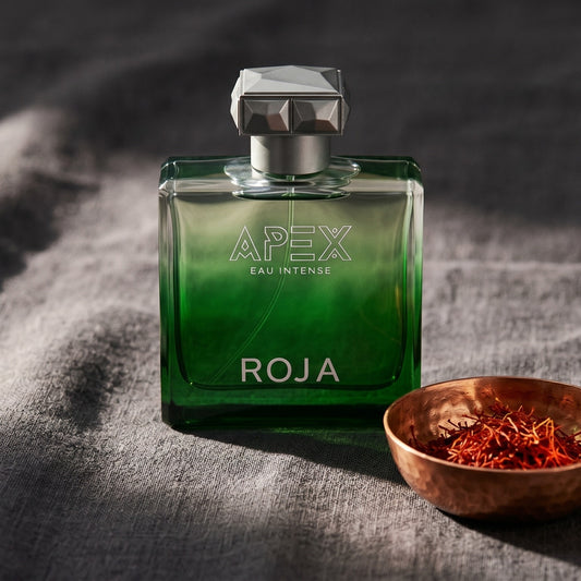 Roja Apex Eau Intense EDP on charcoal canvas with a scatter of dried cloves and cinnamon shards