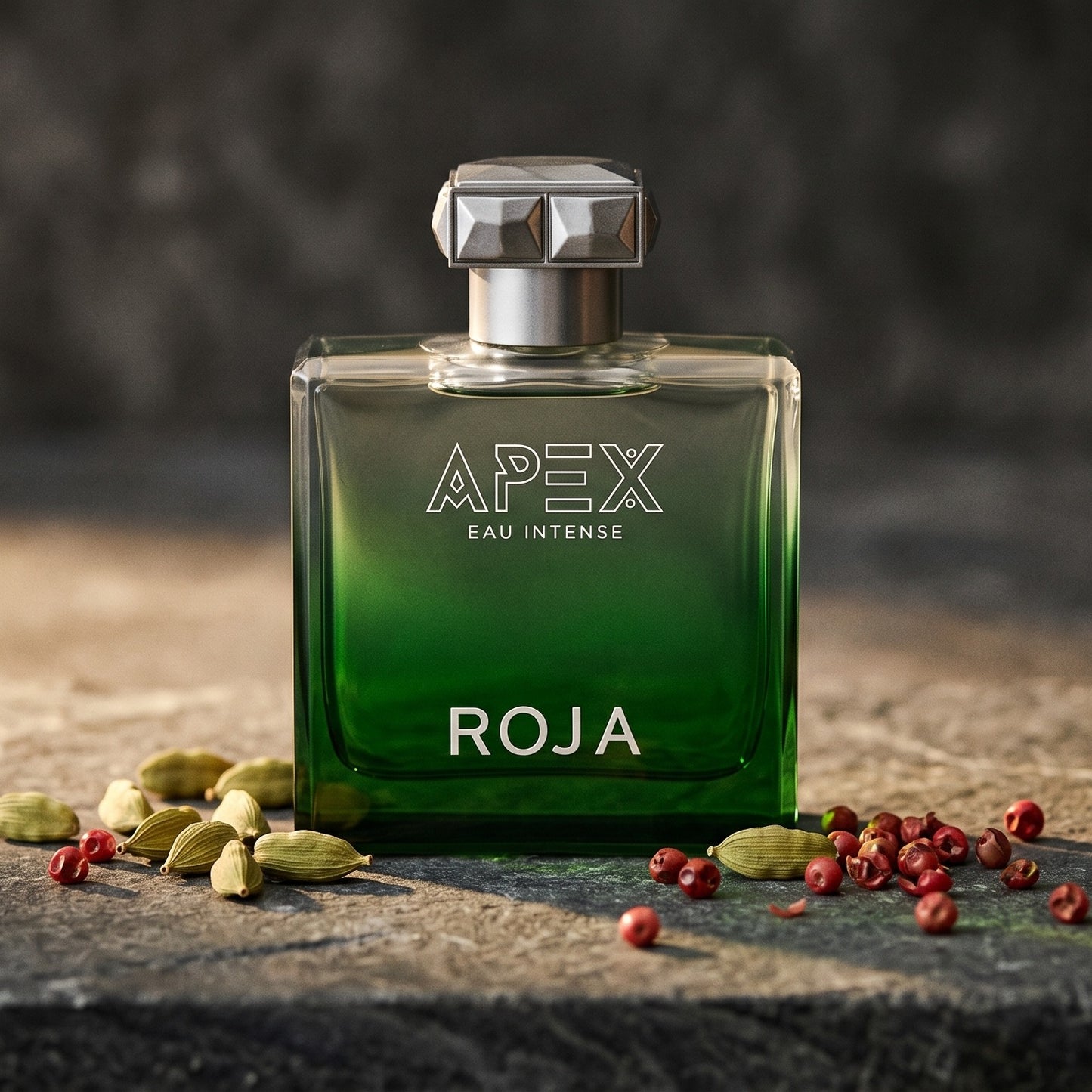 Roja Apex Eau Intense EDP on slate surface with a handful of dried chili threads near the bottle
