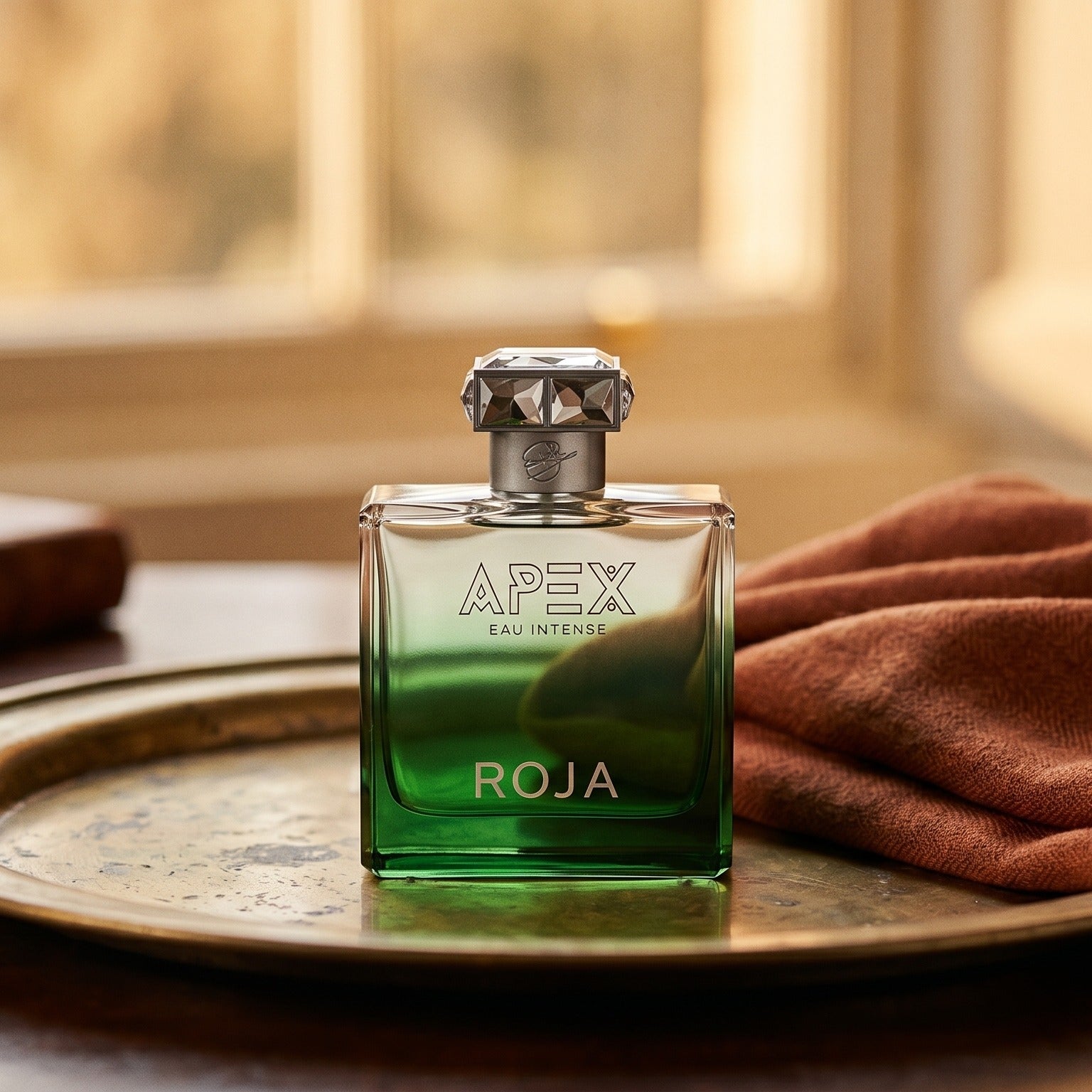 Roja Apex Eau Intense EDP on weathered brass plate with a wool scarf dyed in paprika red