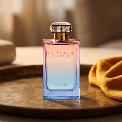 Roja Elysium Pour Femme EDP on patinated bronze tray with a folded shawl in deep saffron