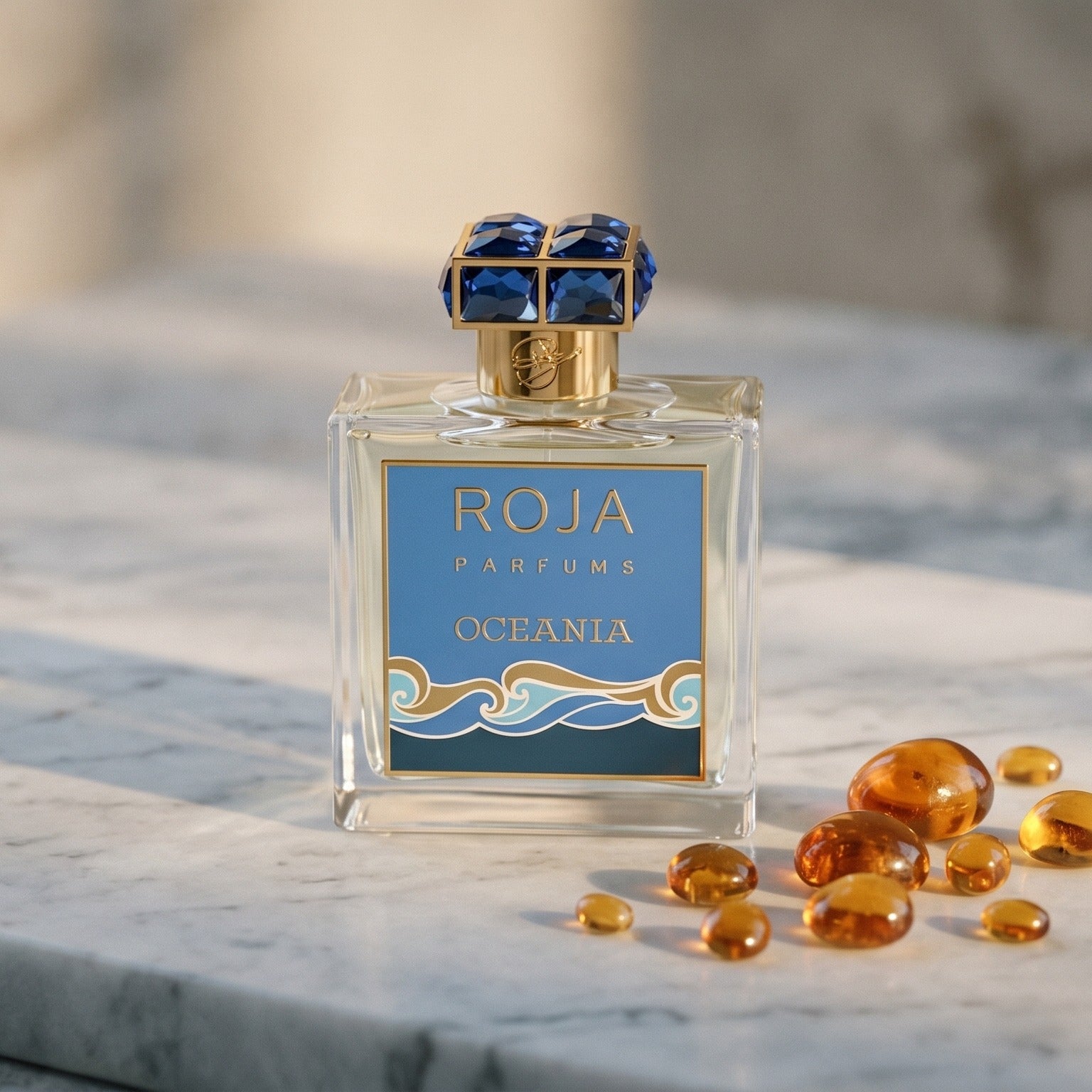 Roja Oceania EDP on pale grey marble with amber resin beads scattered to one side