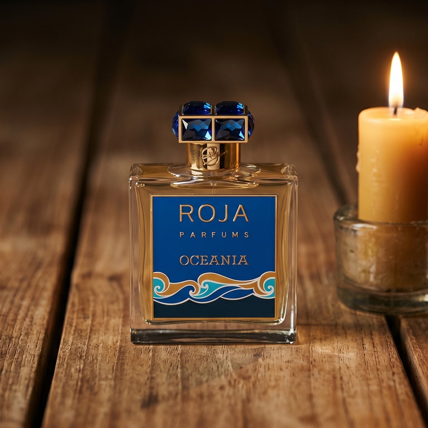 Roja Oceania EDP on walnut side table with a pair of lit votives beside the bottle