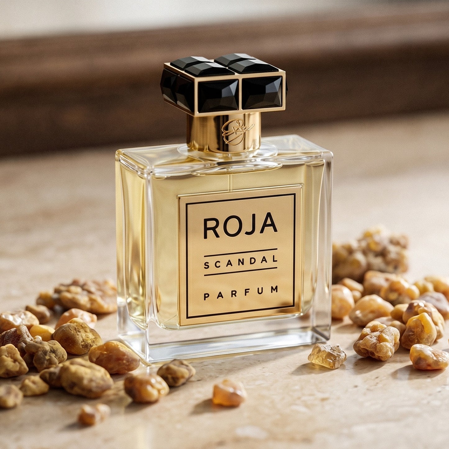 Roja Scandal Pour Homme Parfum on polished limestone with benzoin resin pebbles arranged loosely