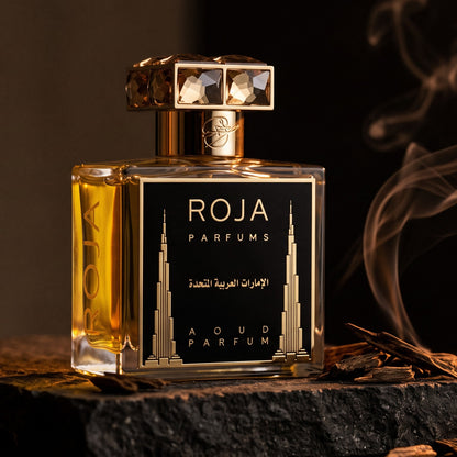 Roja United Arab Emirates Parfum on dark stone with agarwood chips with smoke curling upward
