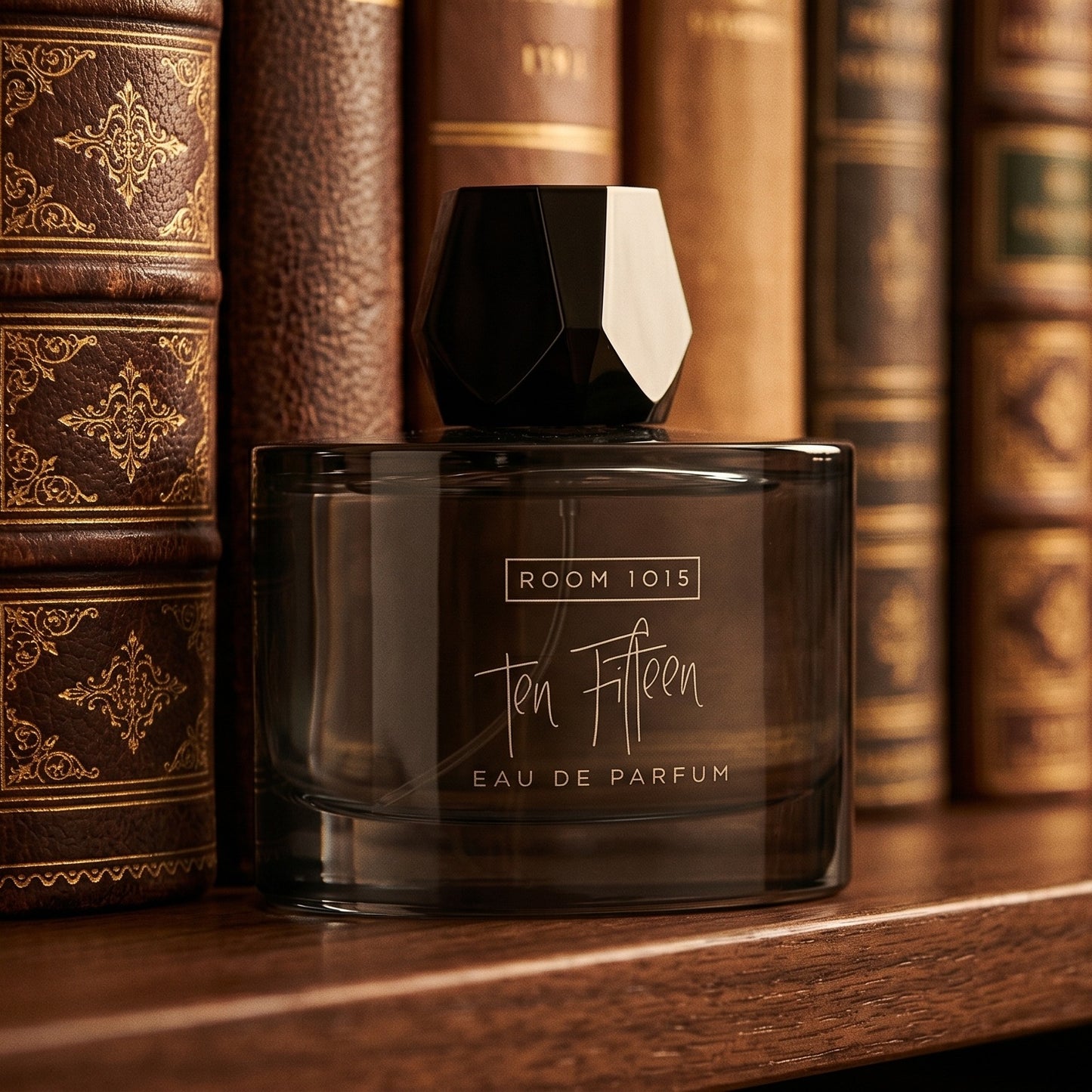 Room 1015 Ten Fifteen EDP on walnut desktop with a tall candle and an open leather diary
