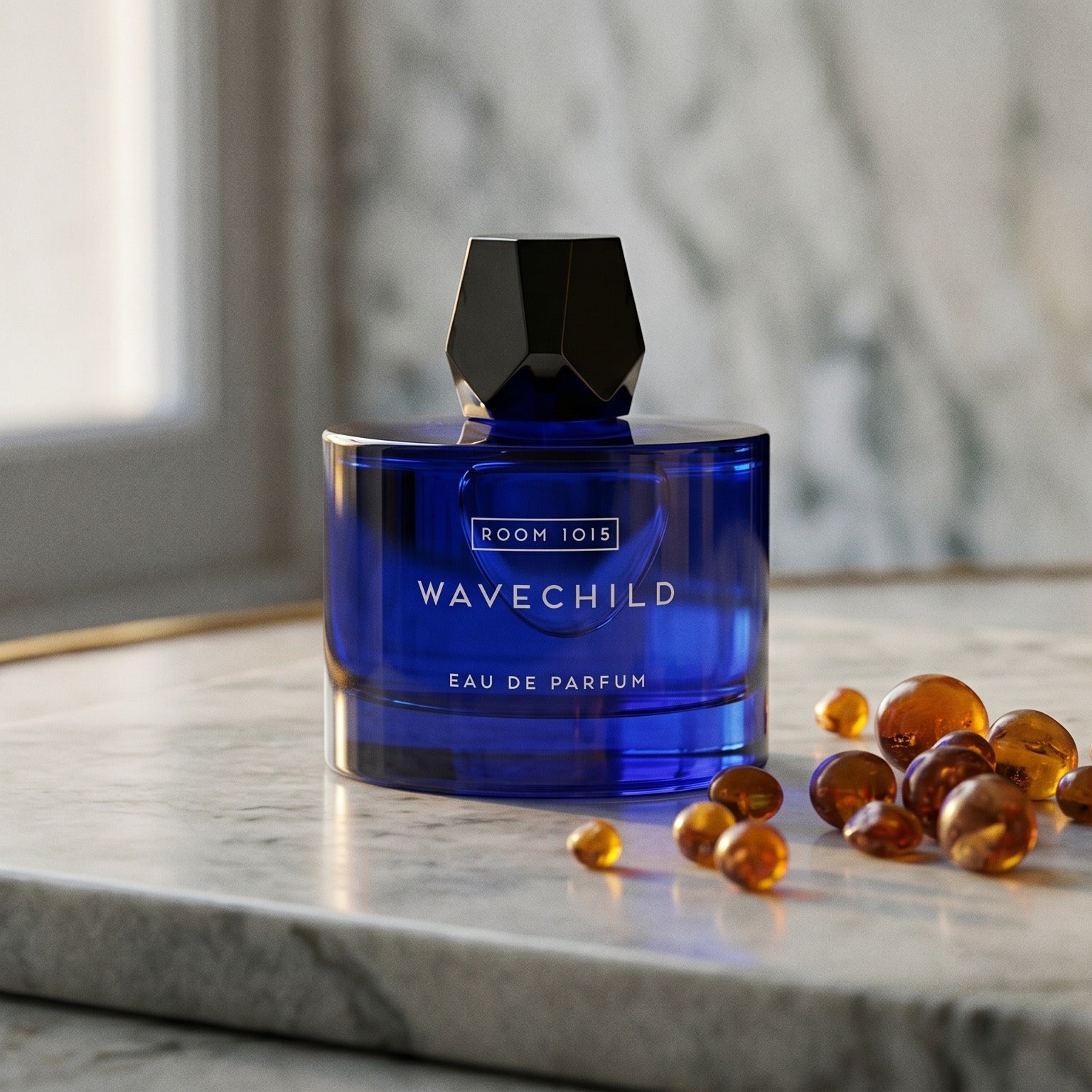Room 1015 Wavechild EDP on warm taupe marble with copal beads spilling from a small dish