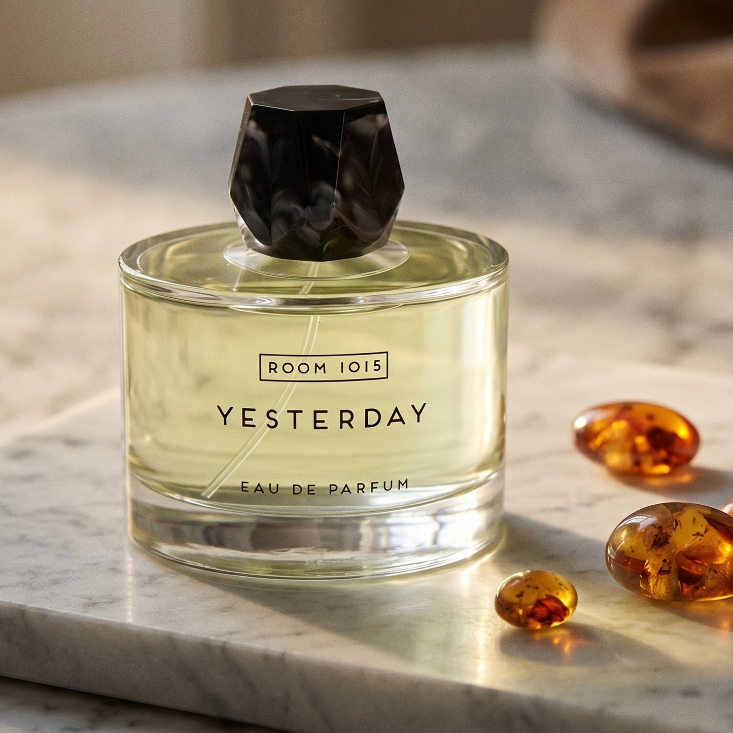 Room 1015 Yesterday EDP on cream stone with a scatter of honey-colored ambergris flakes