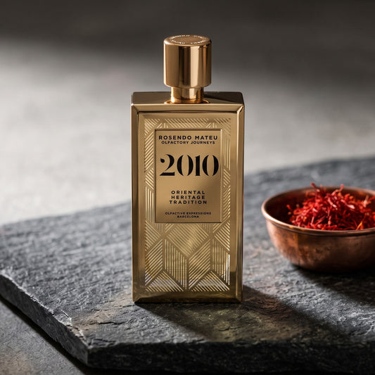 Rosendo Mateu 2010 EDP on dark grey stone slab with saffron threads in a small copper bowl
