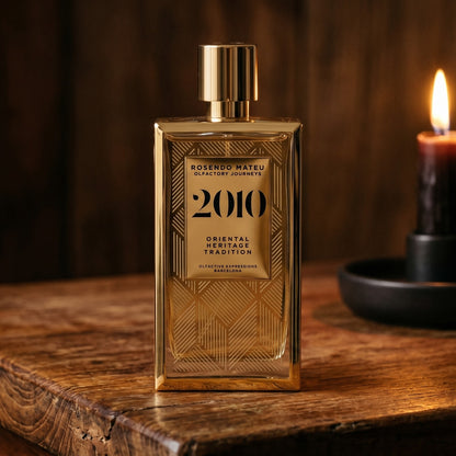 Rosendo Mateu 2010 EDP on aged maple with a slender candlestick and drifting smoke