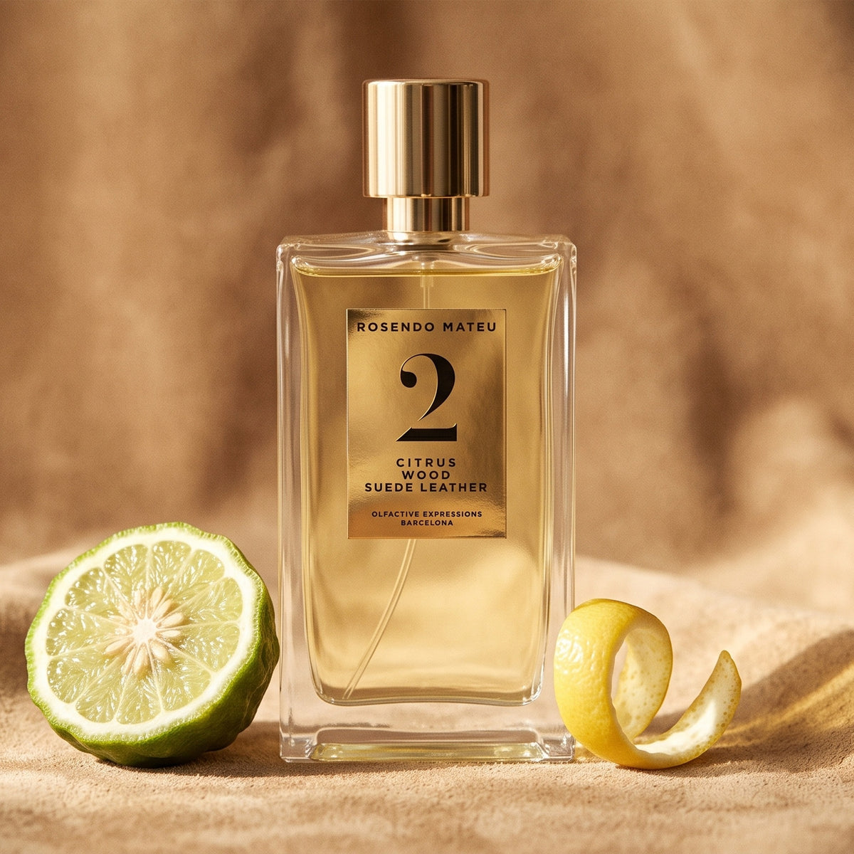 Rosendo Mateu No. 2 EDP on soft tan suede with a halved bergamot and a curl of lemon peel