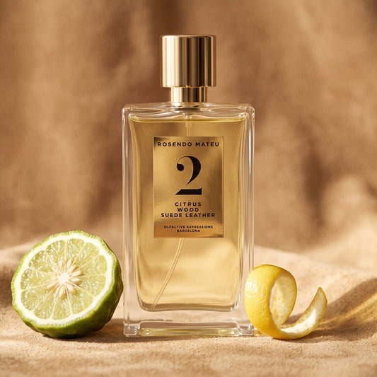 Rosendo Mateu No. 2 EDP on soft tan suede with a halved bergamot and a curl of lemon peel