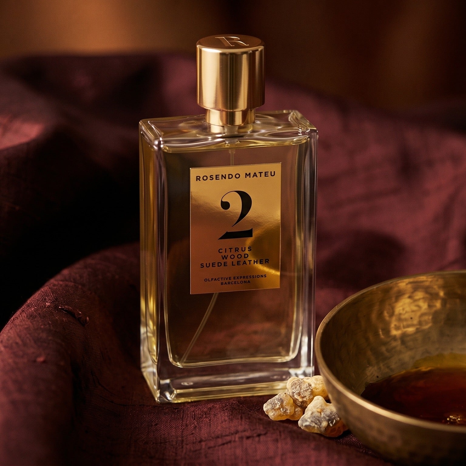 Rosendo Mateu No. 2 EDP on raw silk of oxblood color with a brass bowl of ambergris tincture