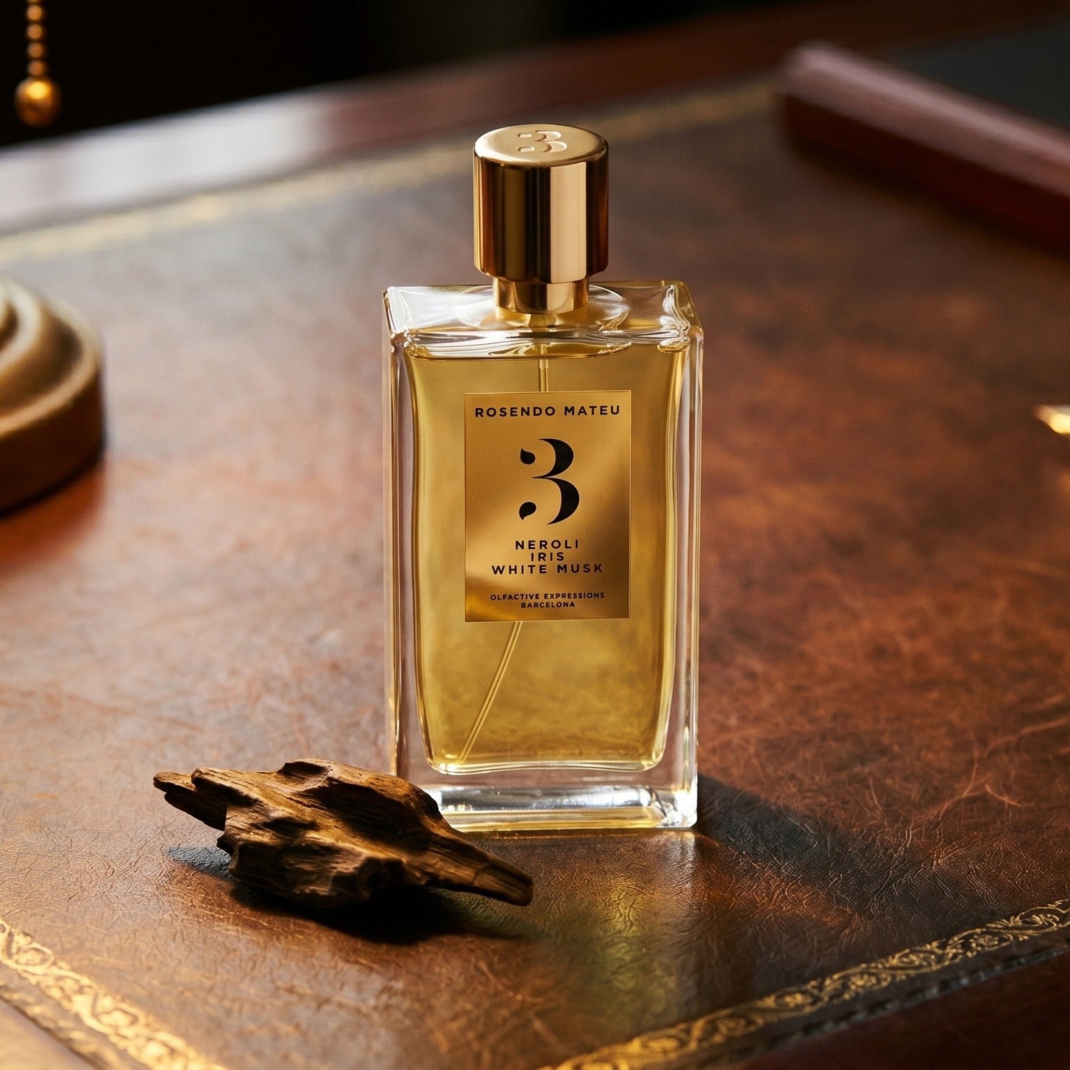 Rosendo Mateu No. 3 EDP on worn saddle-leather surface with oud resin chunks in a small dish