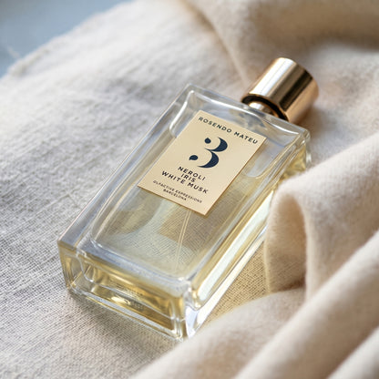 Rosendo Mateu No. 3 EDP on raw pale linen with a length of cashmere folded softly