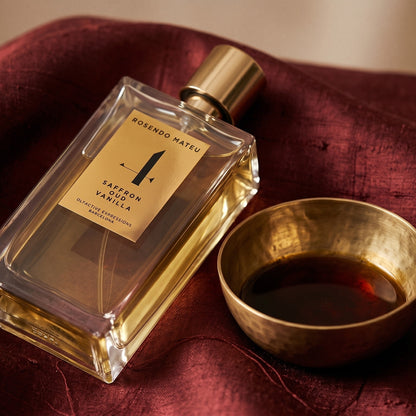 Rosendo Mateu No. 4 EDP on russet silk with a matte brass bowl holding tonka and amber pieces