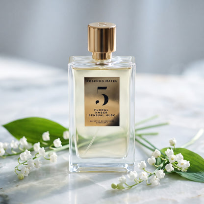 Rosendo Mateu No. 5 EDP on alabaster surface with a few sprigs of lily of the valley
