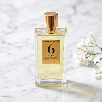 Rosendo Mateu No. 6 EDP on white carrara marble with jasmine sambac sprigs placed to frame-right