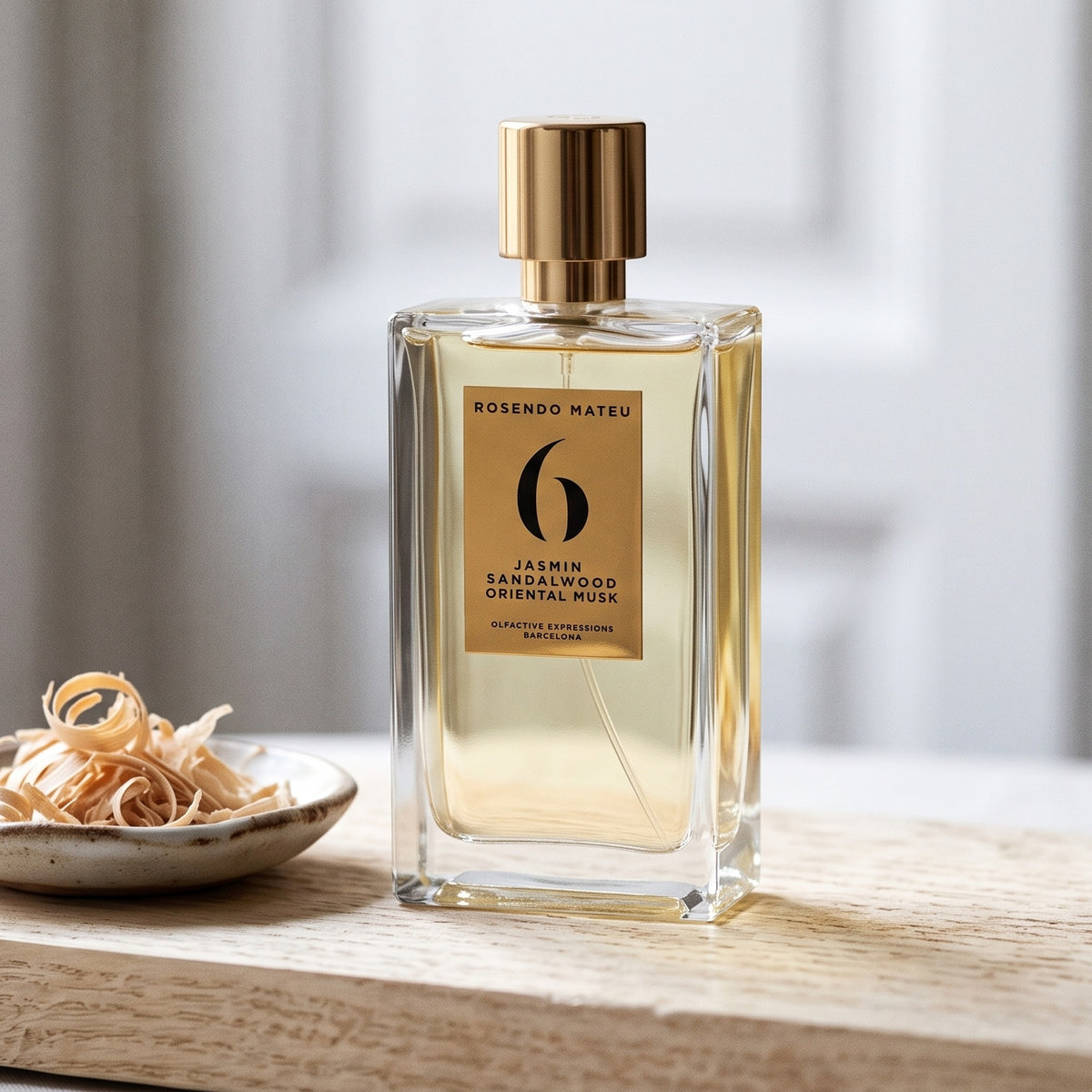 Rosendo Mateu No. 6 EDP on pale sandalwood board with sandalwood shavings in a small dish