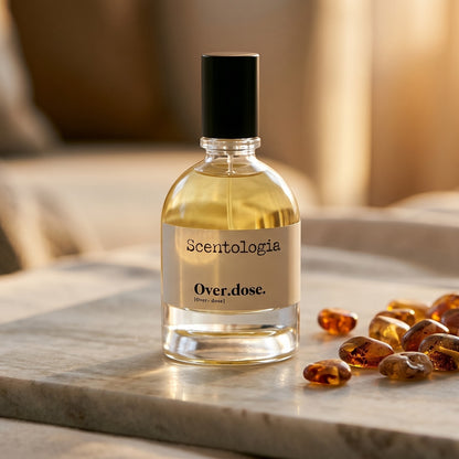 Scentologia Overdose EDP on pale sandstone with golden amber shards catching the light