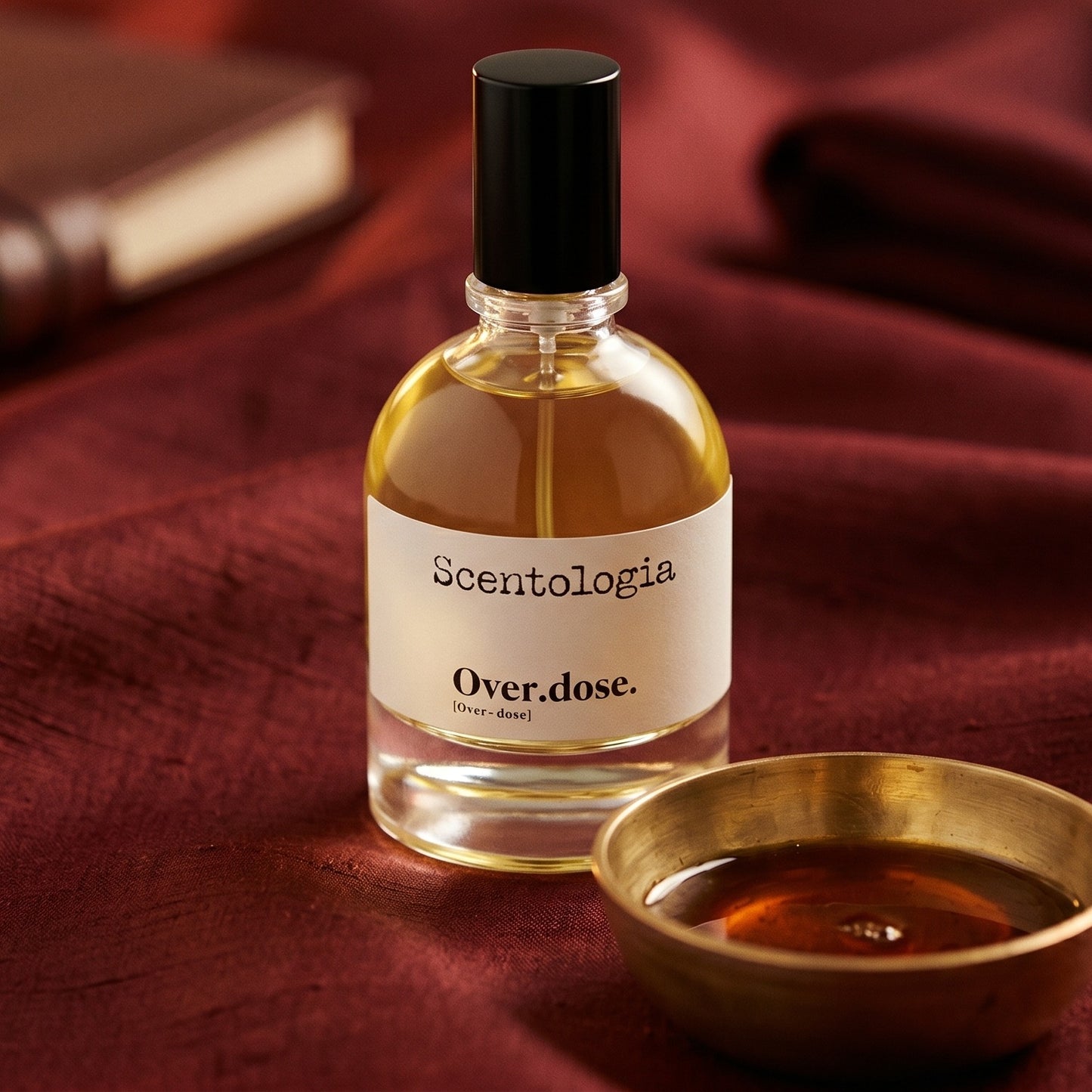 Scentologia Overdose EDP on burnt-orange raw silk with a brass vial of frankincense oil