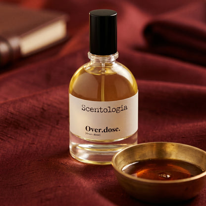 Scentologia Overdose EDP on burnt-orange raw silk with a brass vial of frankincense oil