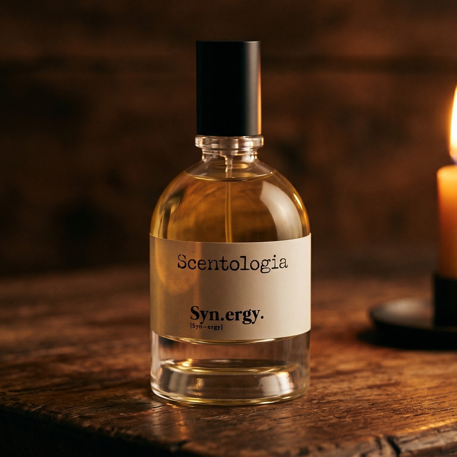 Scentologia Synergy EDP on reclaimed oak surface with a glass hurricane lamp softly glowing