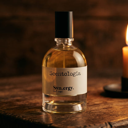Scentologia Synergy EDP on reclaimed oak surface with a glass hurricane lamp softly glowing