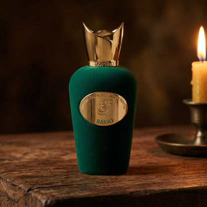 Sospiro Basso EDP on reclaimed oak surface with a glass hurricane lamp softly glowing