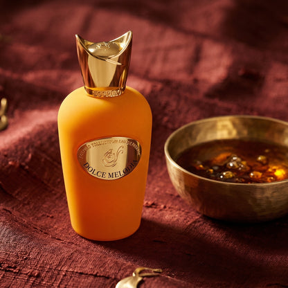 Sospiro Dolce Melodia EDP on burnt-orange raw silk with a brass vial of frankincense oil