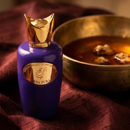Sospiro Erba Pura EDP on amber-toned satin with a gold-rim ceramic dish of labdanum