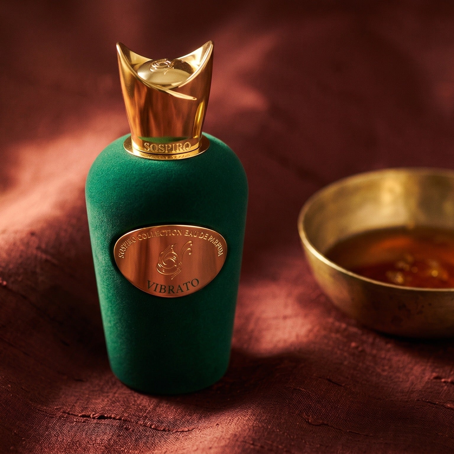 Sospiro Vibrato on russet silk with a matte brass bowl holding tonka and amber pieces