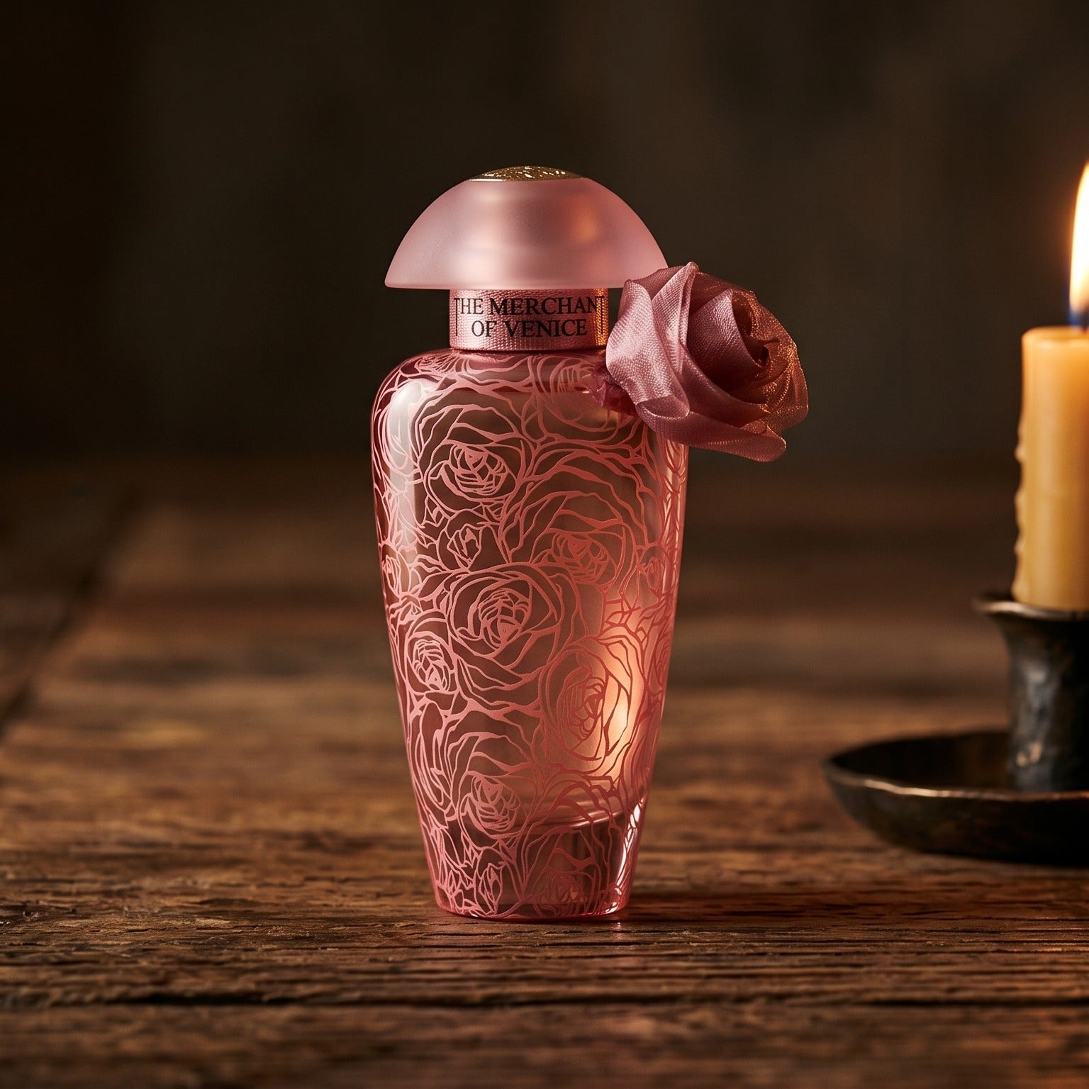 The Merchant of Venice La Fenice Rosa Monceniga Elixir EDP on walnut side table with a pair of lit votives beside the bottle
