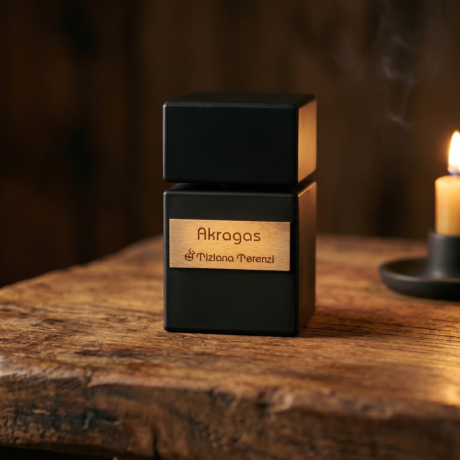 Tiziana Terenzi Akragas EDP on walnut side table with a pair of lit votives beside the bottle