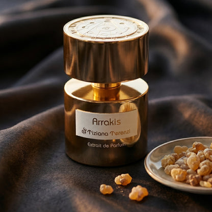 Tiziana Terenzi Arrakis Extrait de Perfume on charcoal raw silk with amber resin pieces near the bottle base