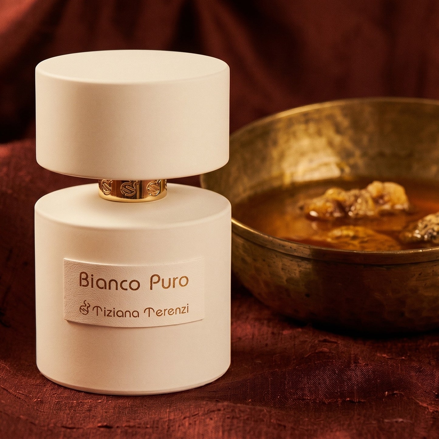 Tiziana Terenzi Bianco Puro on burnt-orange raw silk with a brass vial of frankincense oil