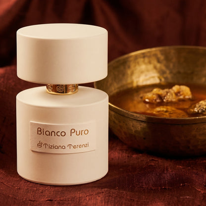 Tiziana Terenzi Bianco Puro on burnt-orange raw silk with a brass vial of frankincense oil