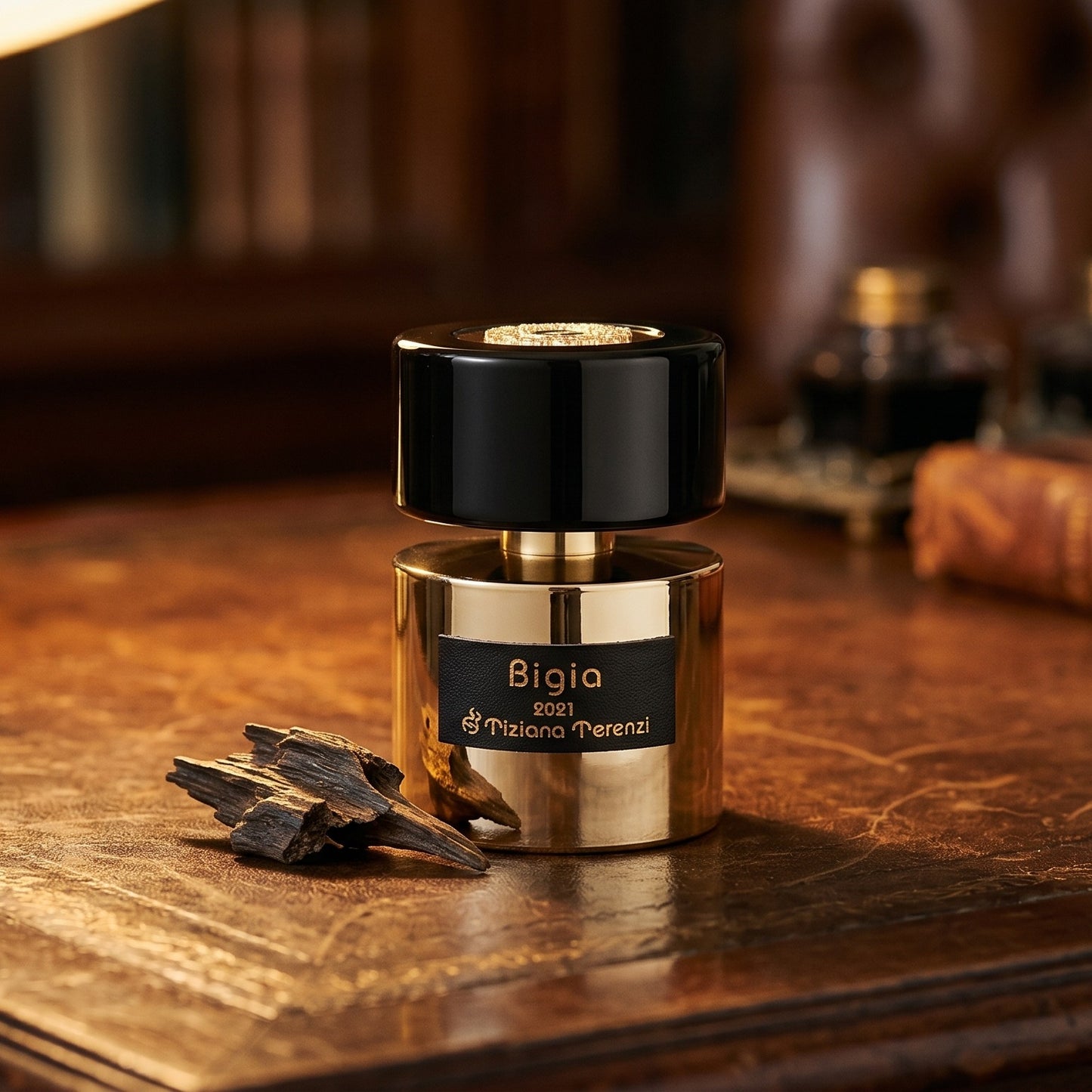 Tiziana Terenzi Bigia EDP on cognac leather bench with a curled strip of birch bark nearby