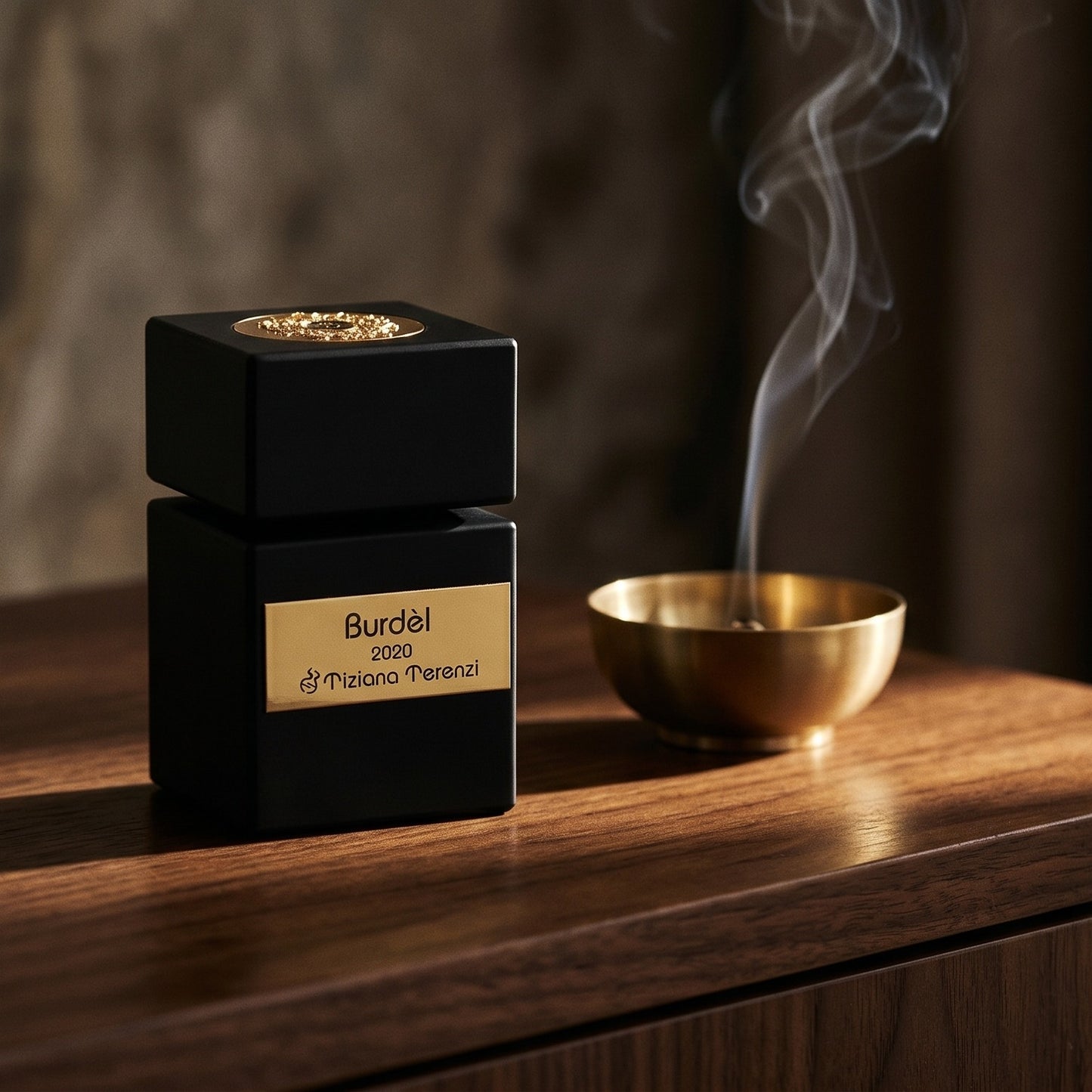 Tiziana Terenzi Burdel EDP on aged walnut board with dried agarwood shavings scattered loosely