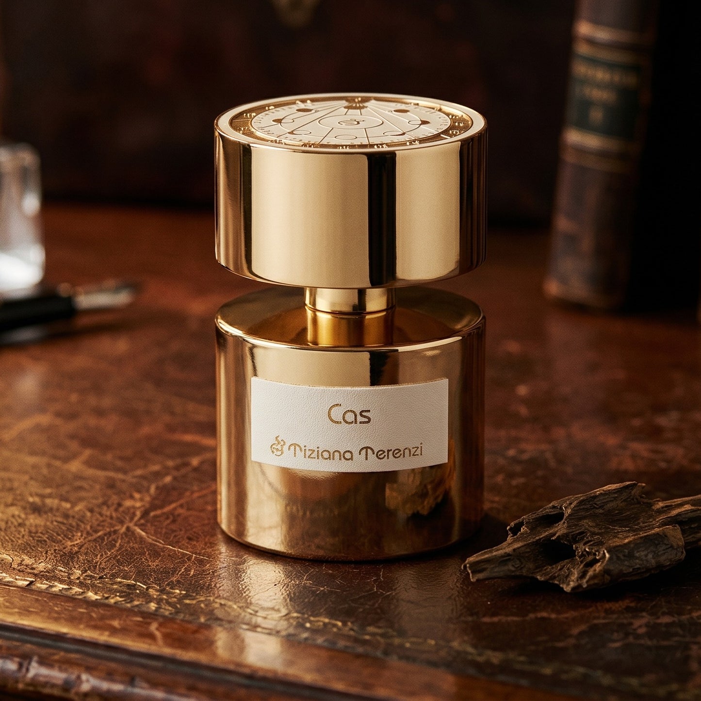 Tiziana Terenzi Cas de Parfum on patinated leather tray with a pinch of frankincense beside the bottle
