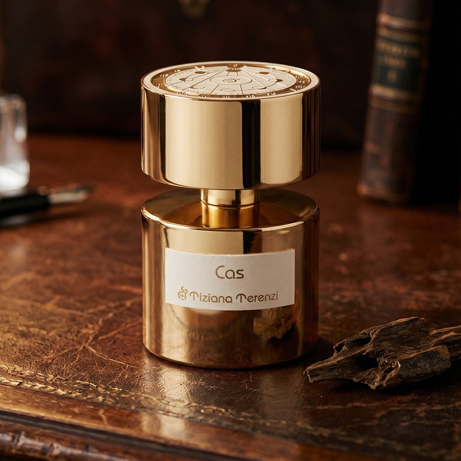 Tiziana Terenzi Cas de Parfum on patinated leather tray with a pinch of frankincense beside the bottle