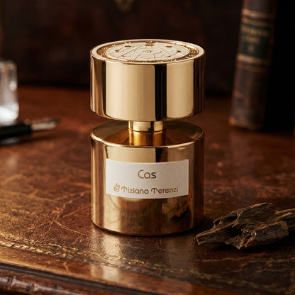 Tiziana Terenzi Cas de Parfum on patinated leather tray with a pinch of frankincense beside the bottle