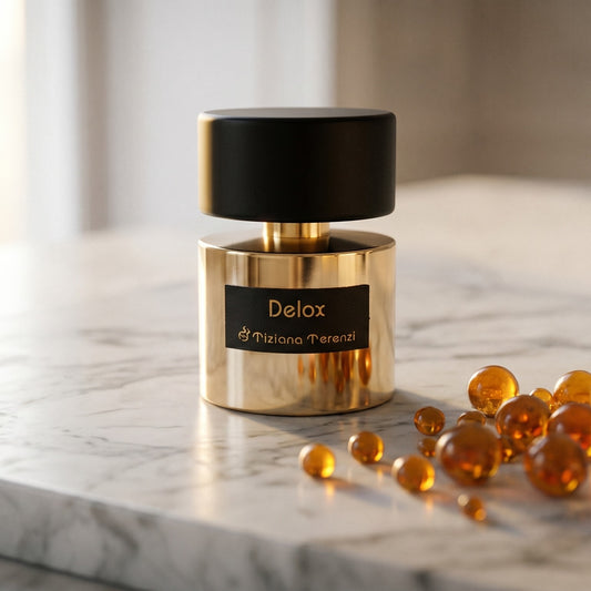 Tiziana Terenzi Delox EDP on pale sandstone with golden amber shards catching the light