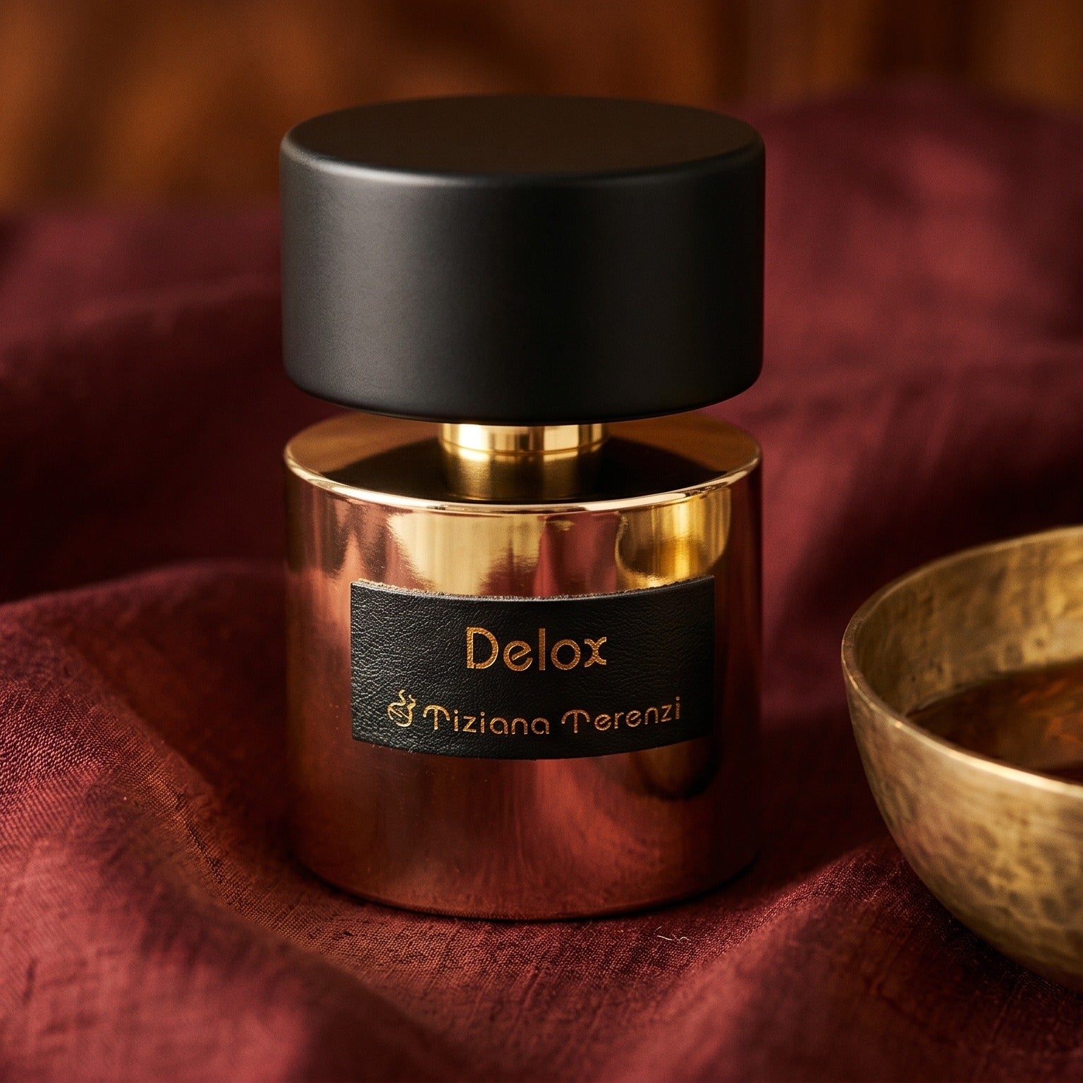 Tiziana Terenzi Delox EDP on cinnamon-tone silk with a shallow saucer of warm benzoin resin